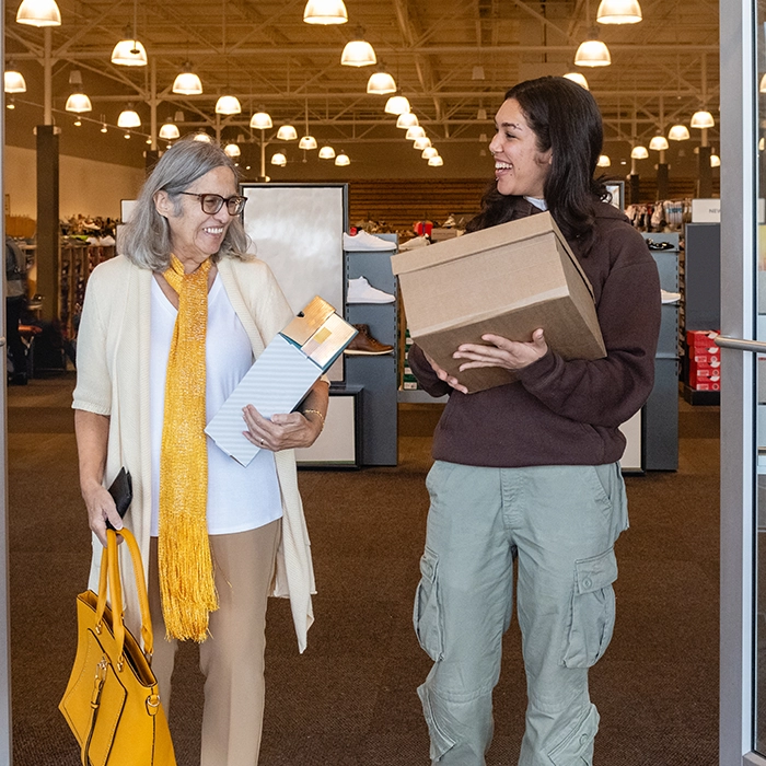Older adult and caregiver completing errands together